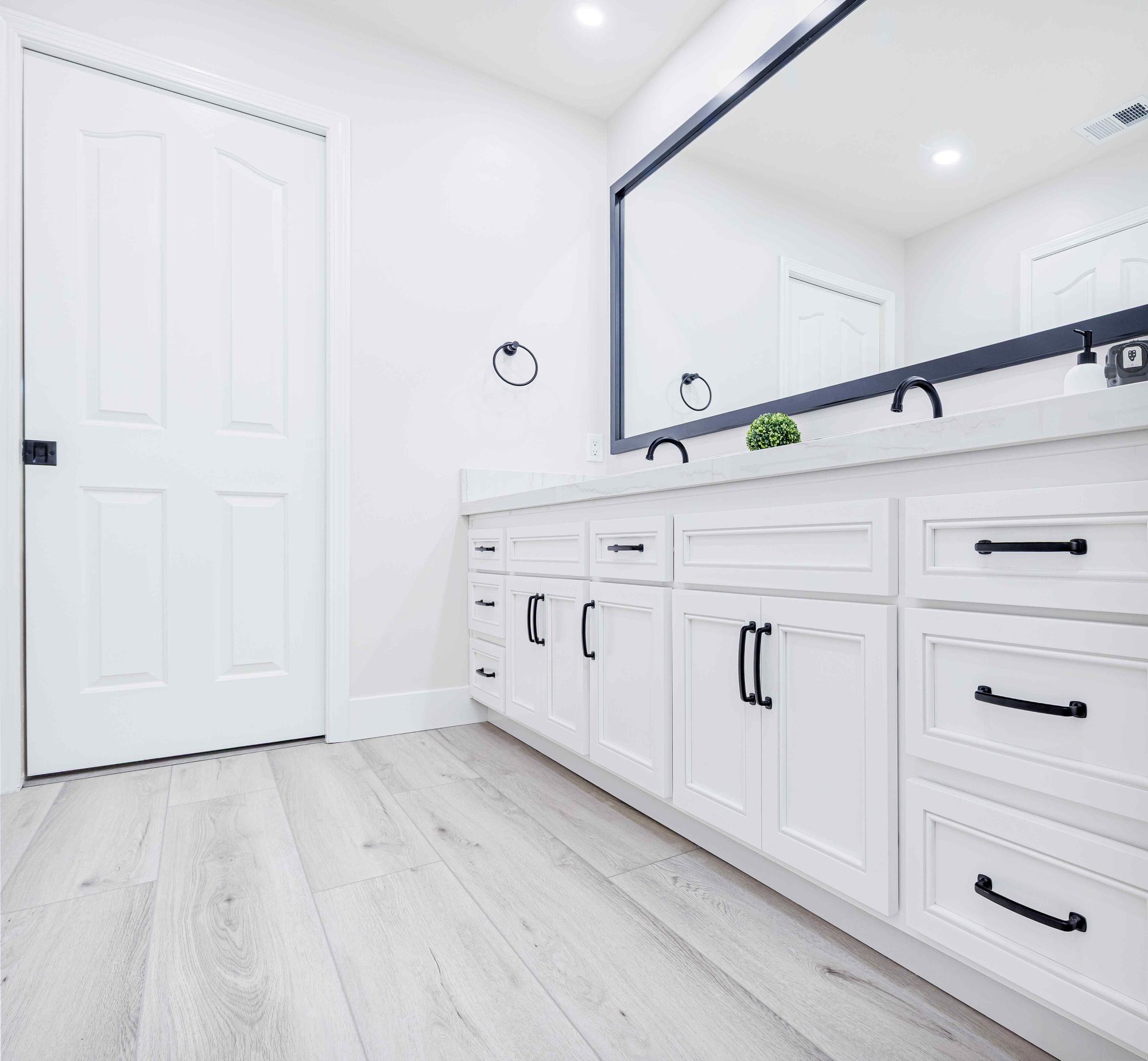 A custom bathroom vanity with a framed mirror