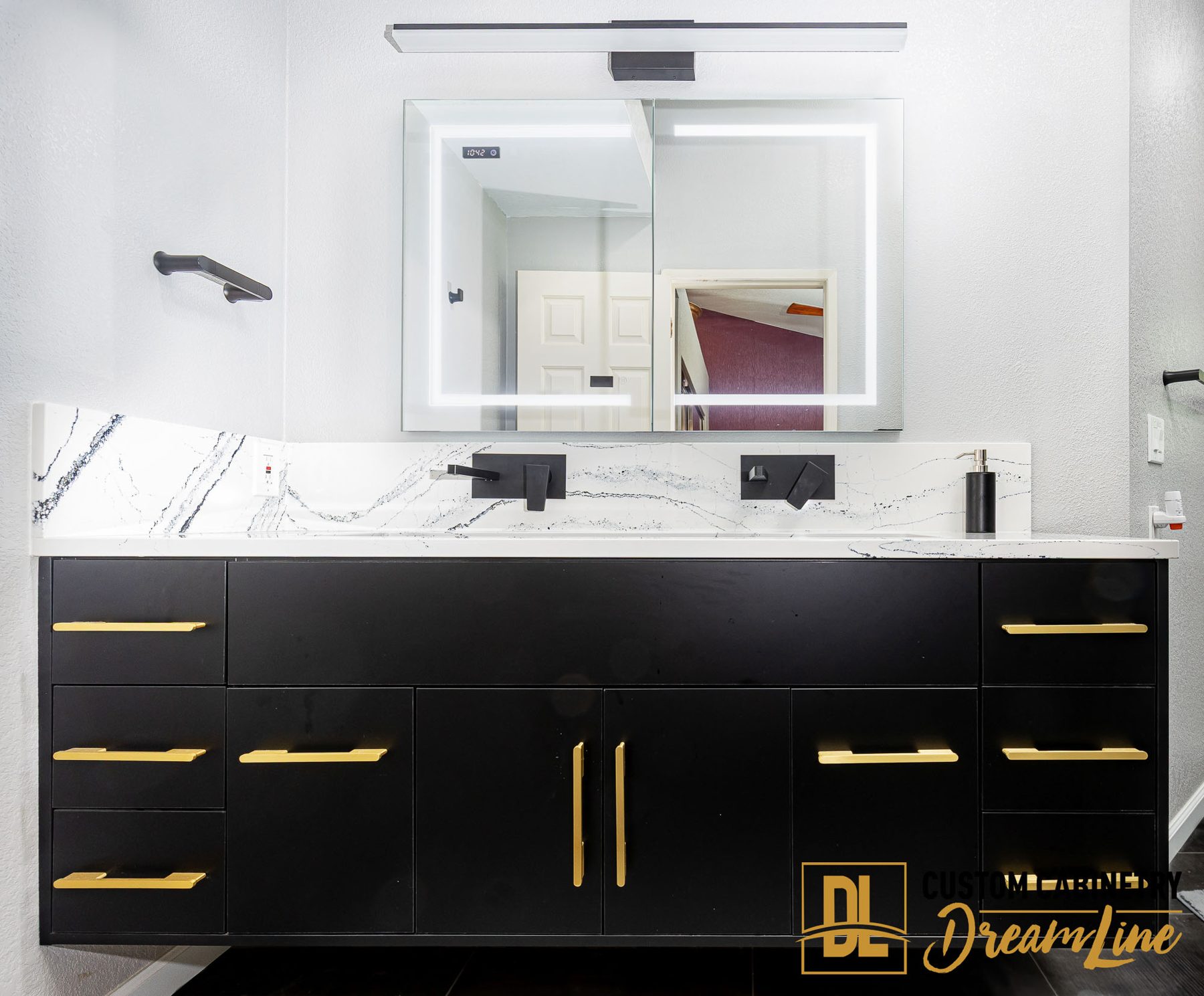 A matte black vanity with brass pulls in Vacaville